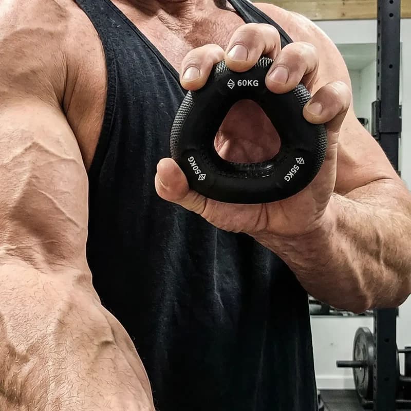 A muscular hand pinching the Onyx grip ring in a gym